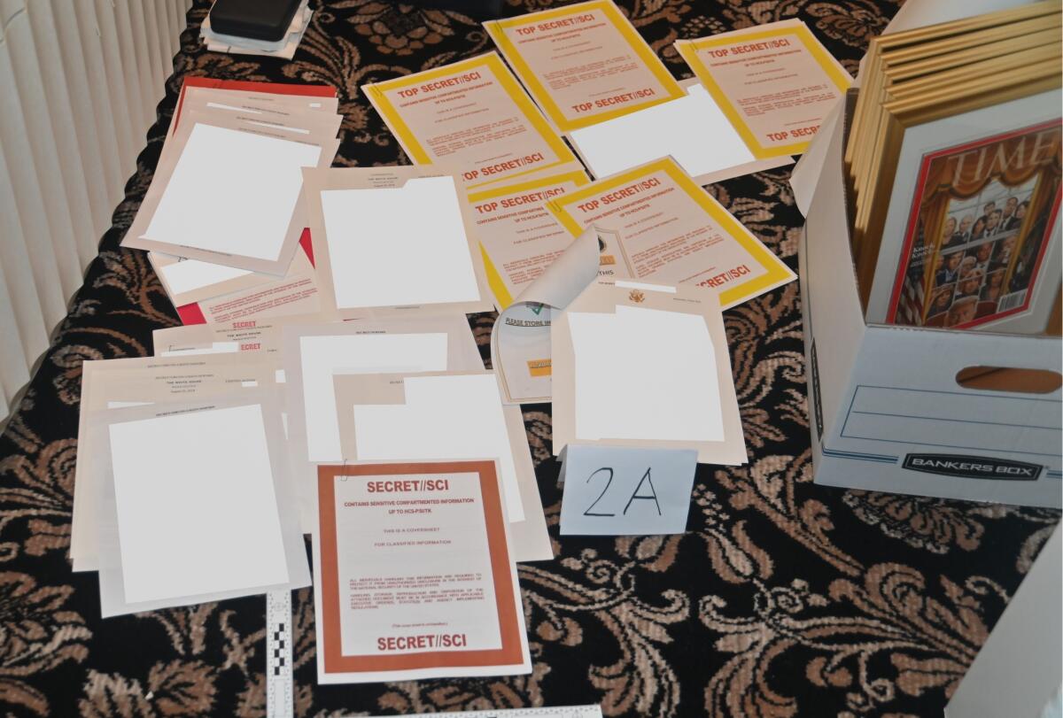 A photo of classified documents seized during a search of Mar-a-Lago strewn about on the floor
