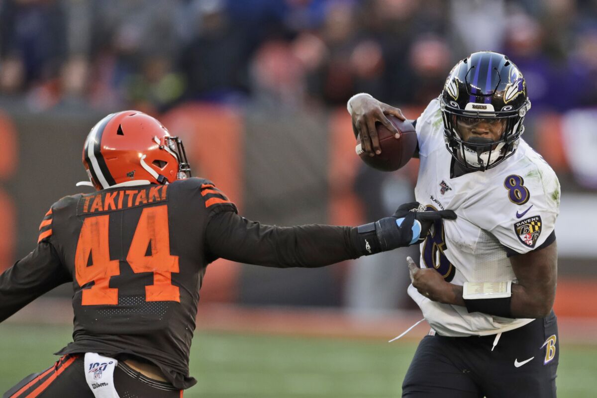 Baltimore Ravens quarterback Lamar Jackson avoids a tackle by Cleveland Browns linebacker Sione Takitaki during the second half on Sunday in Cleveland.