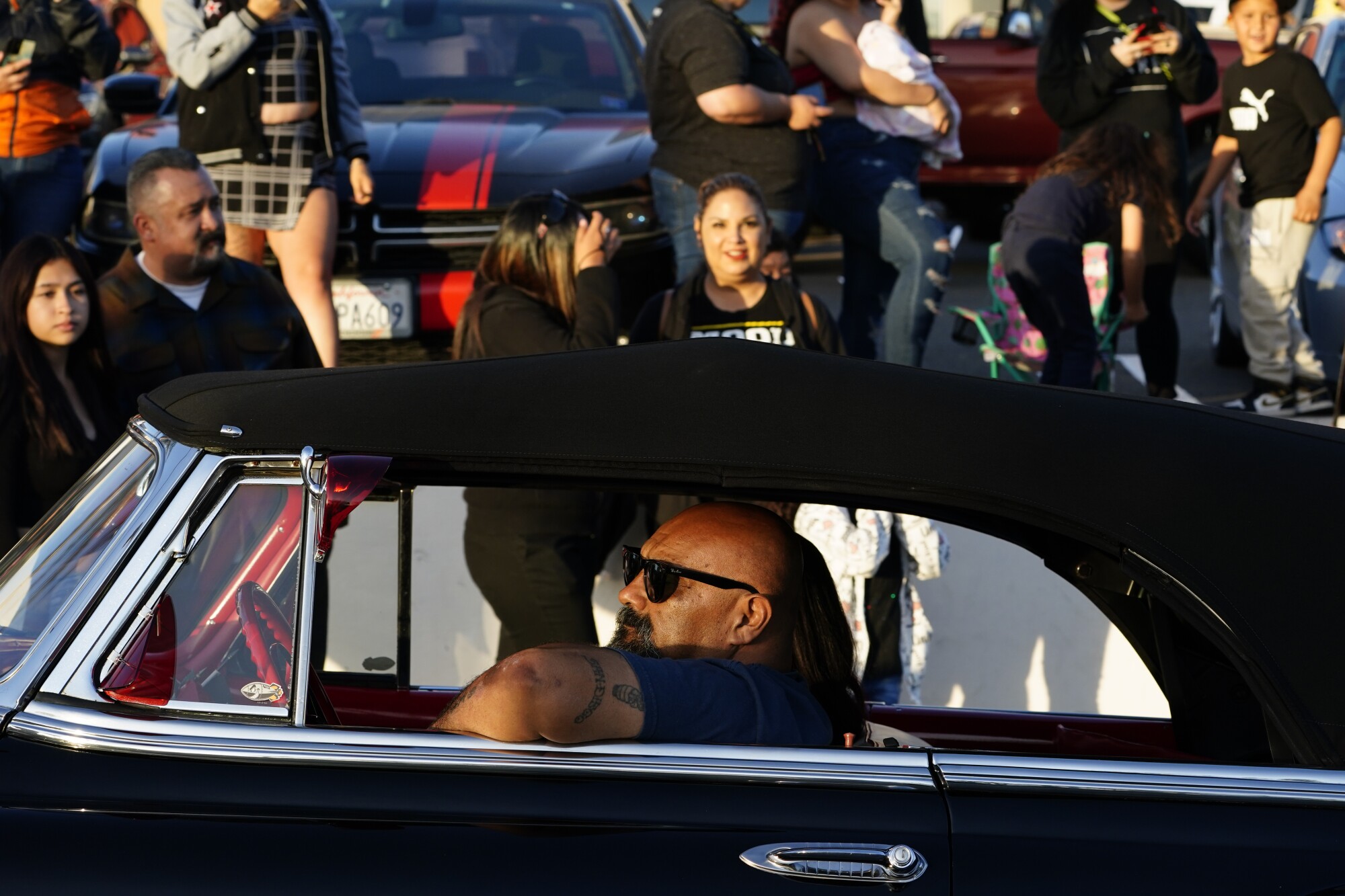 Customized lowriders cruise down Highland Avenue on Friday.