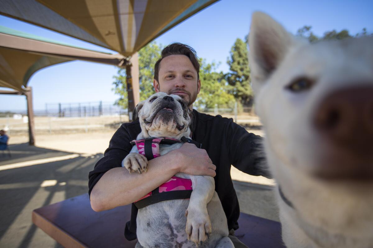 Matt Black holds his dog at the Silver Lake Dog Park in Los Angeles.