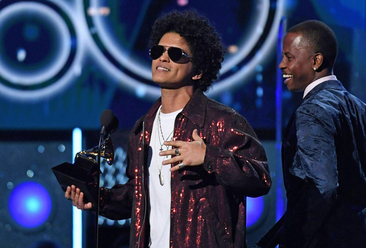 Bruno Mars receives the Grammy for record of the year during the 60th Grammy Awards show on Jan. 28, 2018.