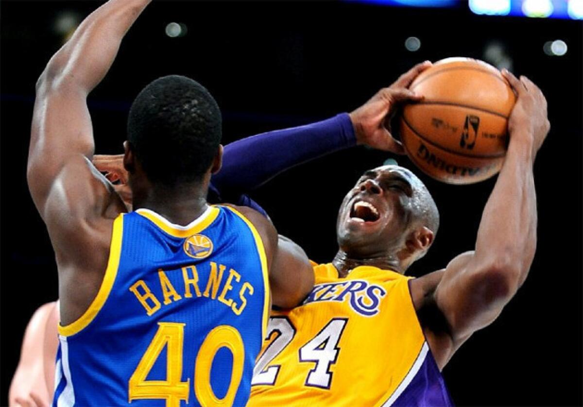 Lakers guard Kobe Bryant, right, attempts a shot over Warriors forward Harrison Barnes.
