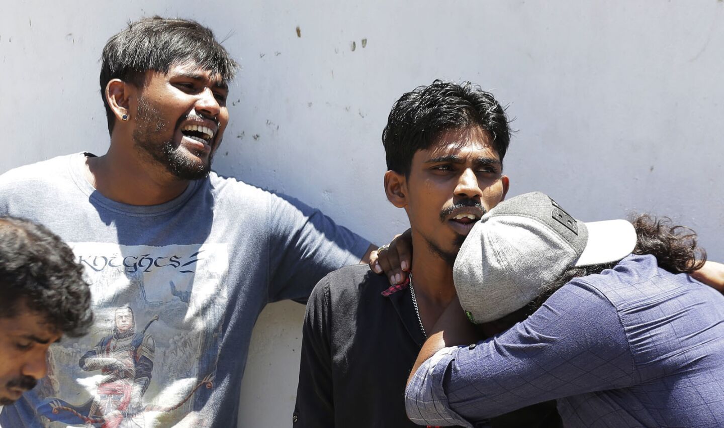 Relatives of bombing victims mourn as they wait outside a hospital mortuary in Colombo, Sri Lanka.
