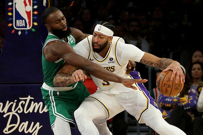 Los Angeles, CA - Lakers big man Anthony Davis drives to the basket against Celtics forward Jaylen Brown.