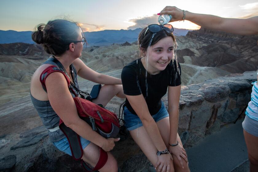 A girl has water poured on her head at Death Valley