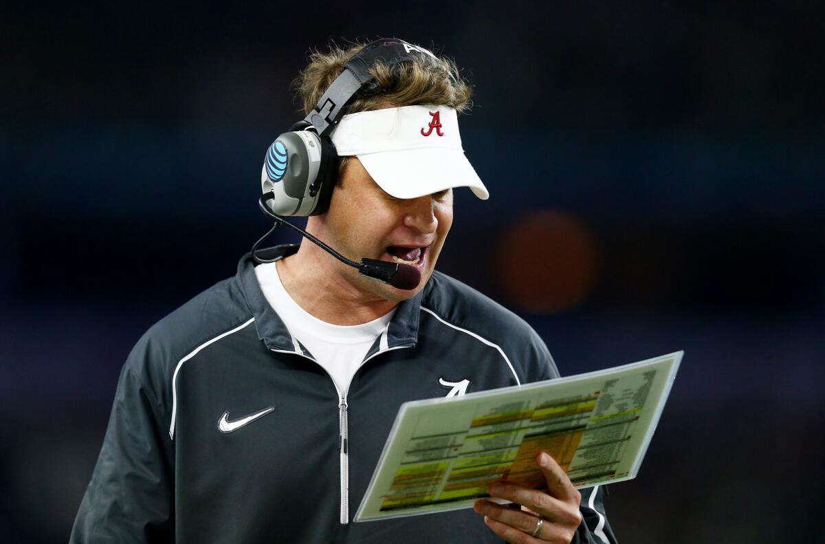 Alabama offensive coordinator Lane Kiffin looks down at his play sheet during the Crimson Tide's 38-0 win over Michigan State at the Cotton Bowl on Dec. 31.