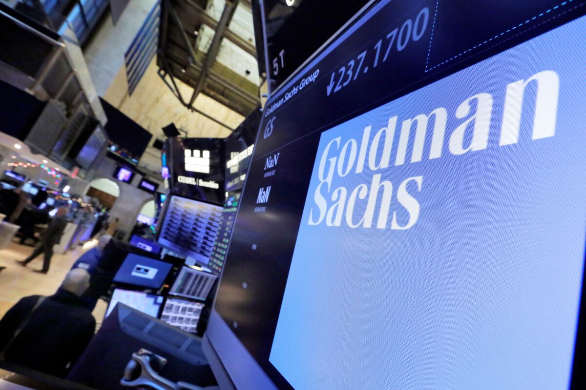 FILE - In this Dec. 13, 2016, file photo, the logo for Goldman Sachs appears above a trading post on the floor of the New York Stock Exchange. Goldman Sachs' profits jumped 60% in the third quarter, Friday, Oct. 15, 2021, as the deal-making bonanza that dominated financial markets this summer brought in hundreds of millions of dollars in fee revenue for the investment bank. (AP Photo/Richard Drew, File)