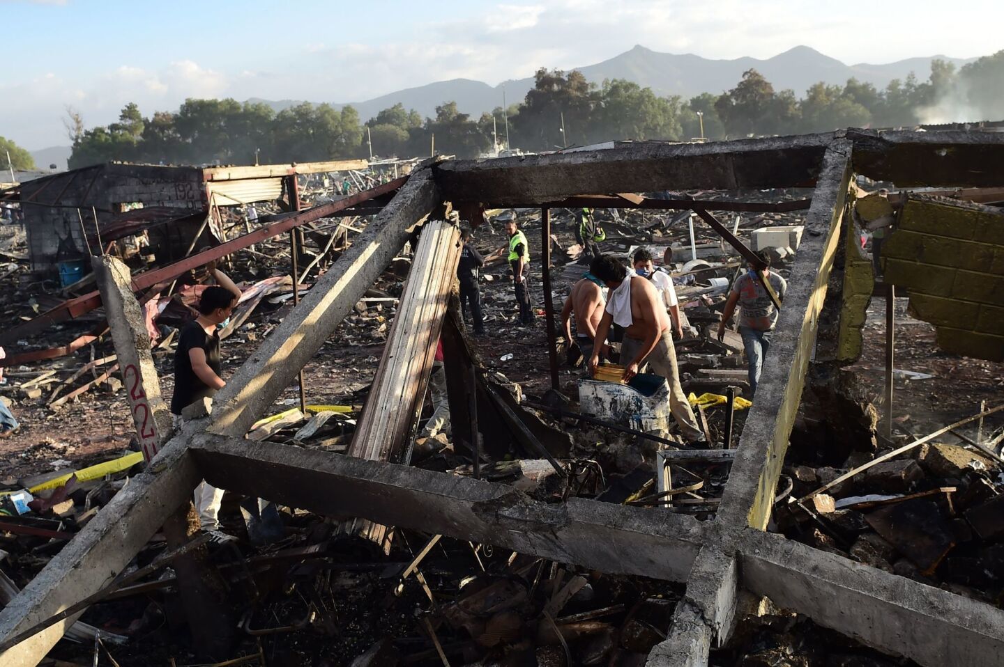 Survivors search the ruins left by a series of explosions at a fireworks market north of Mexico City.