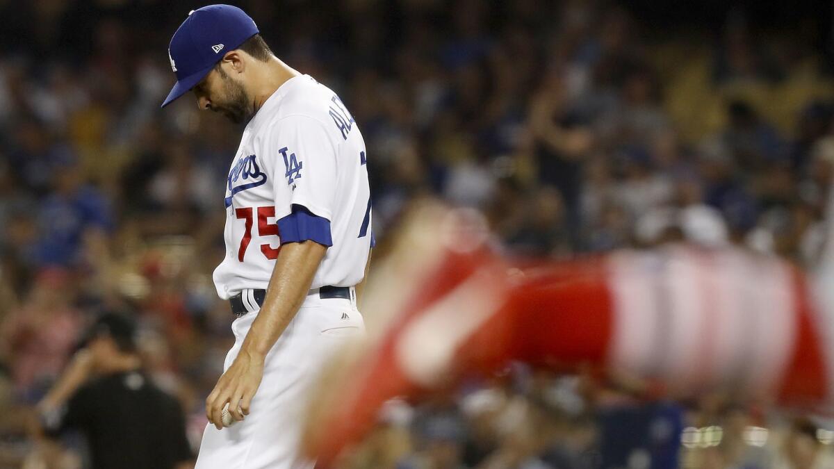 Dodgers reliever Scoot Alexander reacts after giving up a solo home run to Cardinals outfielder Tyler O'Neill in the eighth inning.