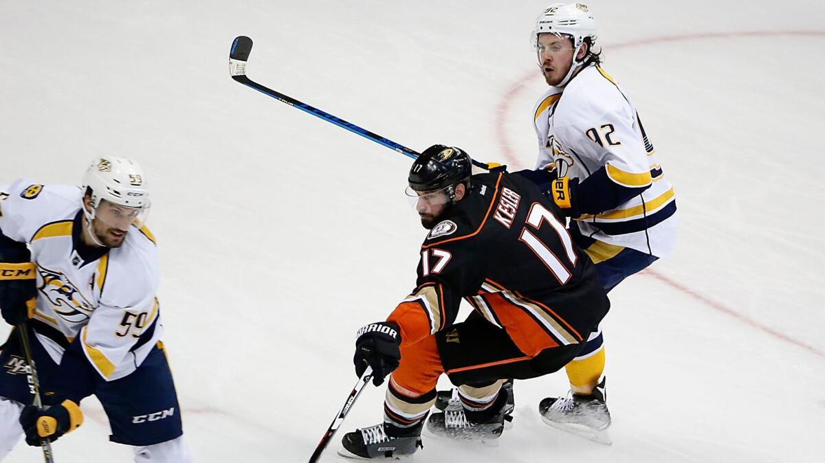 Ducks' Ryan Kesler (17) is shadowed by Nashville's Ryan Johansen, right, as he takes on Roman Josi during Game 2 of the Western Conference finals on Sunday.