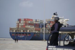 A Naval officer stand guards as a shipping containers is seen at the Lekki deep seaport prior to its commission by Nigeria's President Muhammadu Buhari in Lagos, Nigeria, Monday, Jan. 23, 2023. Nigeria's President Muhammadu Buhari on Monday commissioned a Chinese-built and -funded $1.5 billion deep seaport in the commercial hub of Lagos with authorities optimistic the project would help grow the West African nation's ailing economy. (AP Photo/Sunday Alamba)