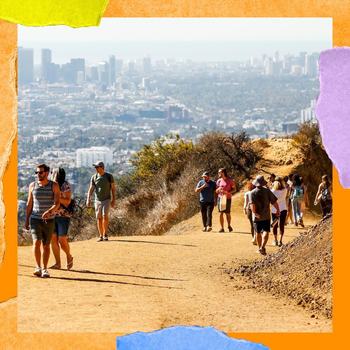 People walk on a dirt hiking trail in the hills.