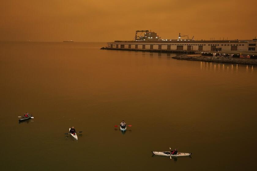 People in kayaks paddle in McCovey Cove outside Oracle Park during the sixth inning of a baseball game between the San Francisco Giants and the Seattle Mariners on Wednesday, Sept. 9, 2020, in San Francisco. (AP Photo/Tony Avelar)