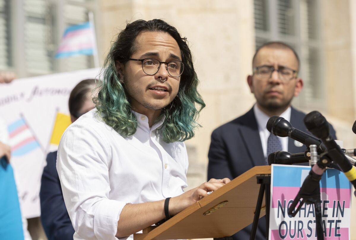 Adri Perez, ACLU of Texas Policy and Advocacy Strategist, speaks at a rally in support of transgender children and their families at the Heman Marion Sweatt Travis County Courthouse in Austin, Texas, on Wednesday March 2, 2022. LGBTQ allies and community organizations hosted the rally hours after a hearing for the lawsuit ACLU of Texas and Lambda Legal filed to block the state of Texas from opening up an abuse investigation for parents who provide their children with gender-affirming medical care. (Jay Janner/Austin American-Statesman via AP)