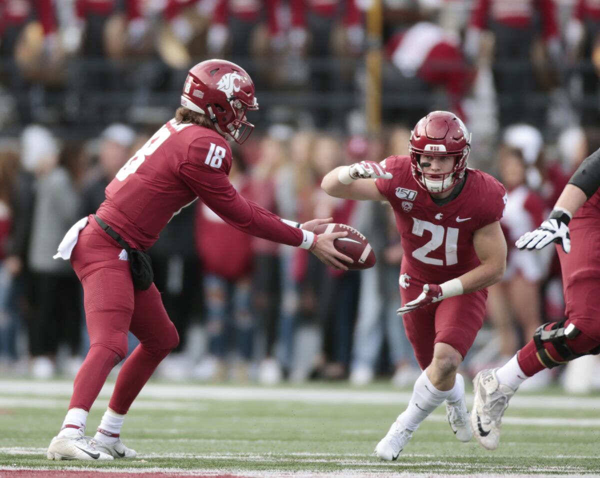 Washington State quarterback Anthony Gordon prepares to hand off to Max Borghi during the first half against Stanford on Nov. 16, 2019, in Pullman, Wash.