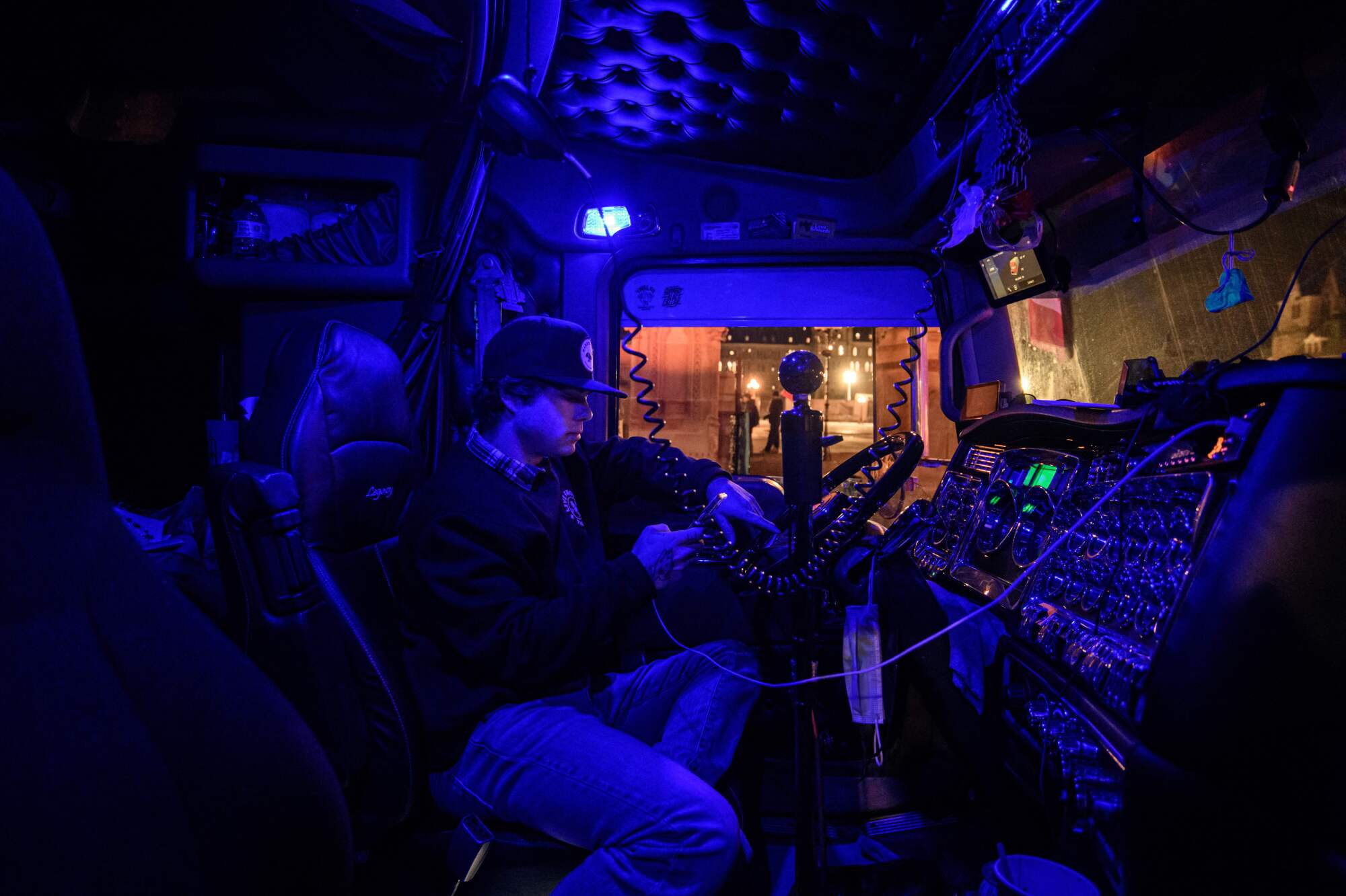 A driver sits in the cab of his truck 