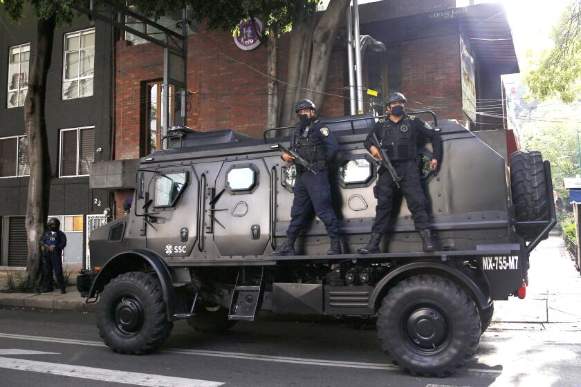 A police vehicle arrives to the place where an abandoned vehicle that is believed to have been used by gunmen in an attack against the chief of police was found, in Mexico City, Friday, June 26, 2020. Heavily armed gunmen attacked and wounded Omar Garcia Harfuch in a brazen operation that left an unspecified number of dead, Mayor Claudia Sheinbaum said Friday. (AP Photo/Marco Ugarte)