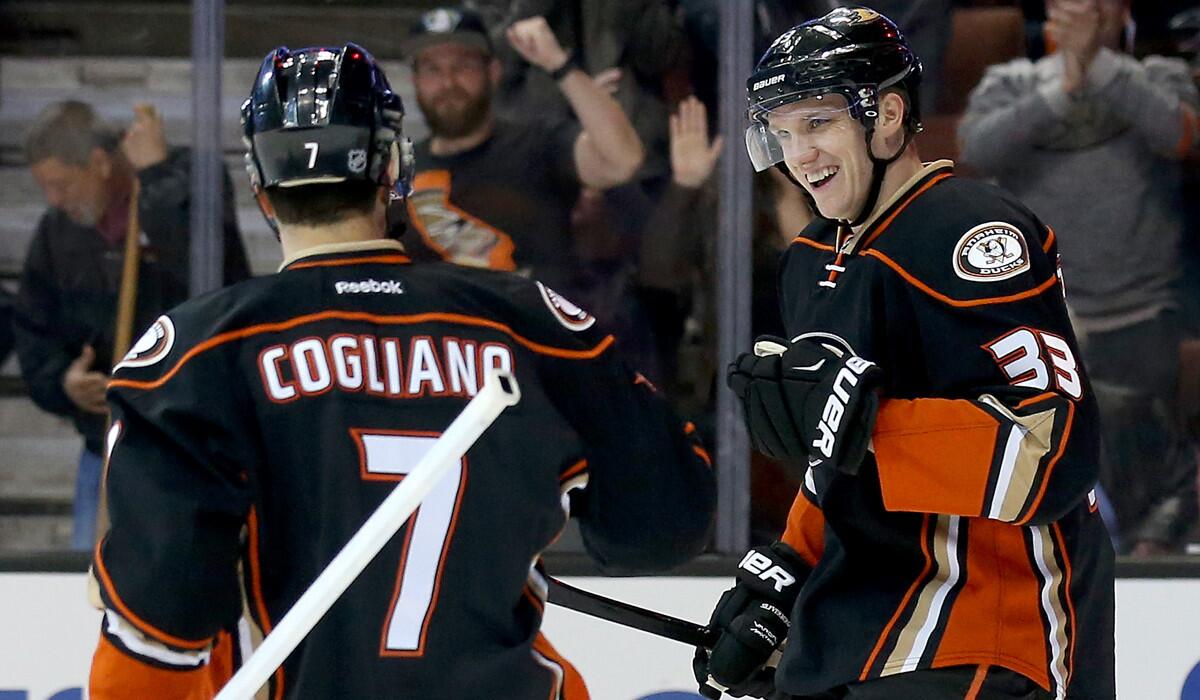 Ducks forward Jakob Silfverberg, right, celebrates after scoring the second of three first-period goals against the Flames on Wednesday.