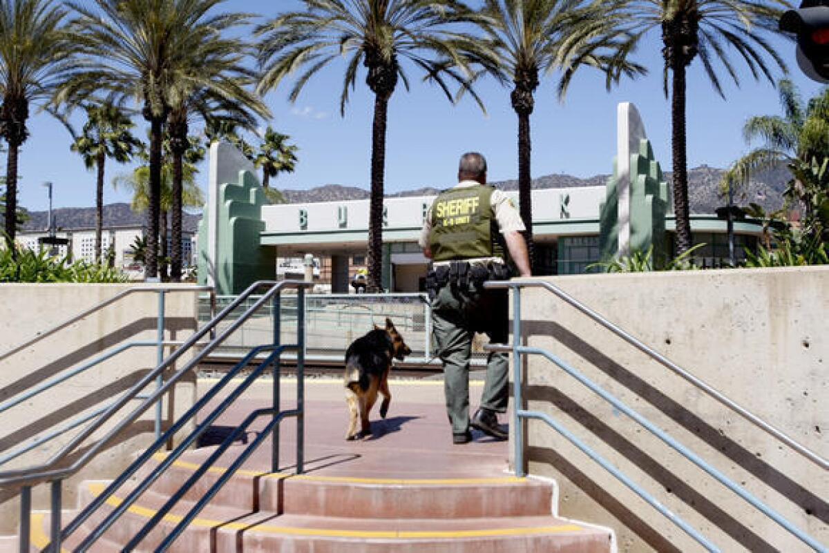 Los Angeles County Sheriff's Department officials investigate a bomb threat at a Burbank Metrolink station.
