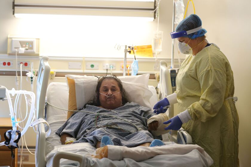 Memorial Hospital nurse Angela Bilyeu flushes the IV of patient Pedro Cortez in a COVID-19 unit on Friday, July 24, 2020. Medical facilities in Kern County are being pushed to the limit as more and more people contract COVID-19.
