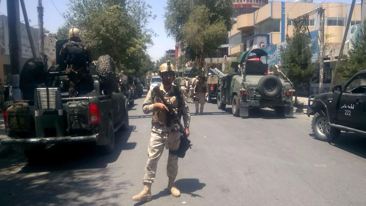Afghan security forces arrive at the site of an explosion in Kabul on July 31.