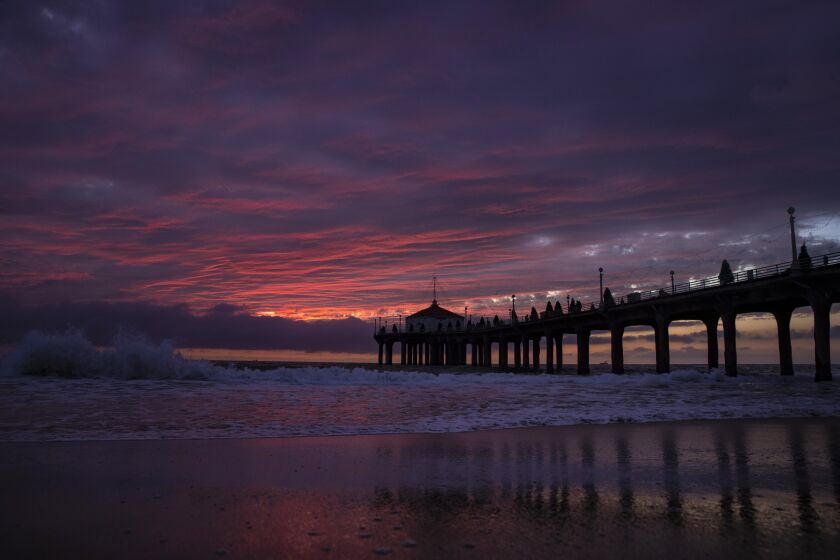 Brian van der Brug  Los Angeles Times SUNSET RAINDROPS Rain arrives in Manhattan Beach as a large storm system from the north begins to move across the Southland, bringing cooler temperatures, more rainfall and mountain snow through Wednesday.