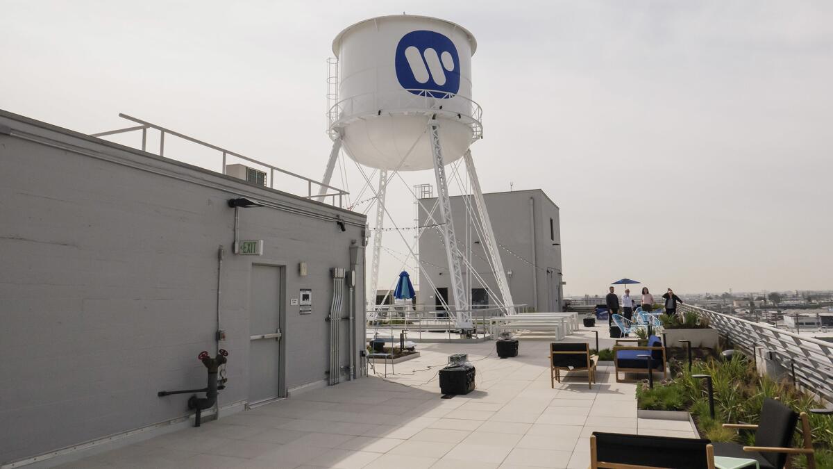 The rooftop water tower of the former Ford automobile factory now sports the Warner logo.