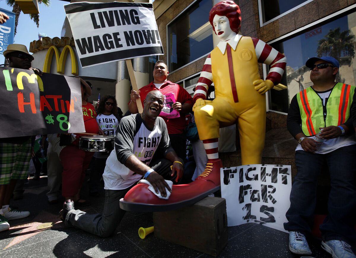 Protesters demand a $15-an-hour minimum wage in Los Angeles. McDonald's is facing several lawsuits alleging wage theft.