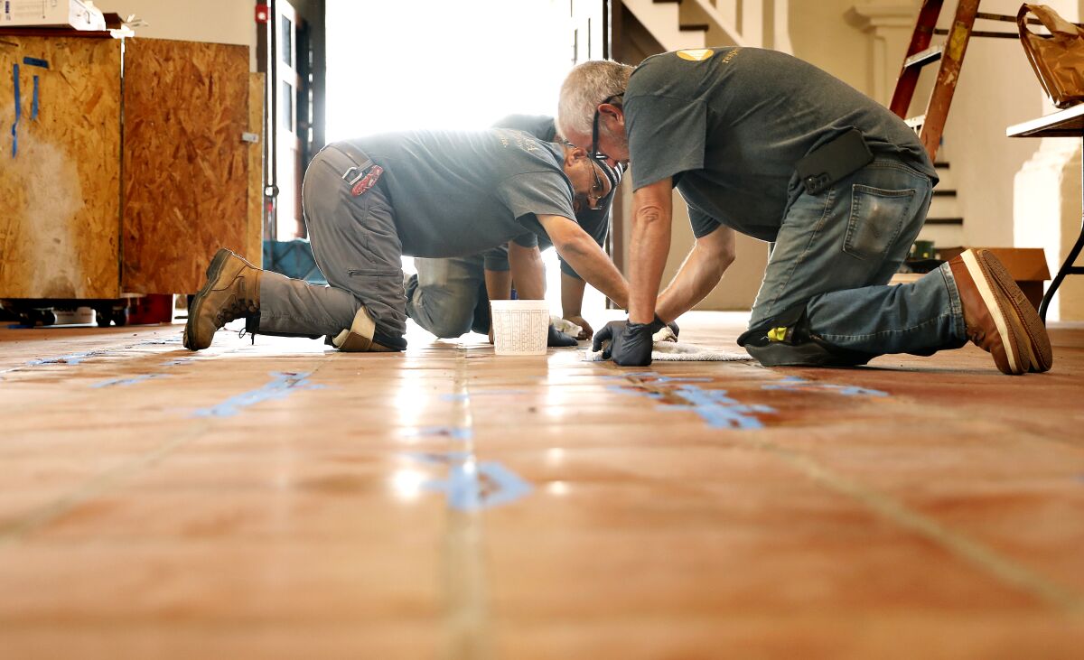 Workers fix the floors at the San Gabriel Mission, 