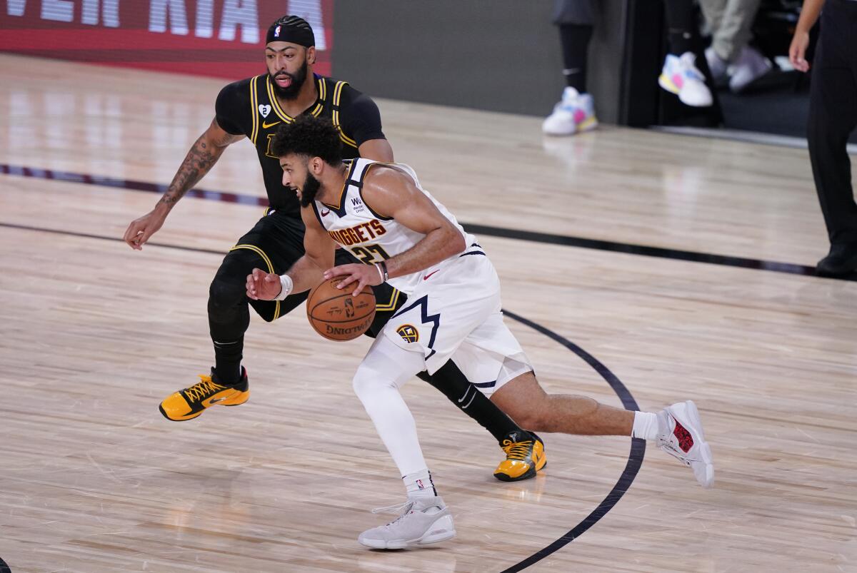Nuggets guard Jamal Murray (27) drives Lakers forward Anthony Davis during Game 2.