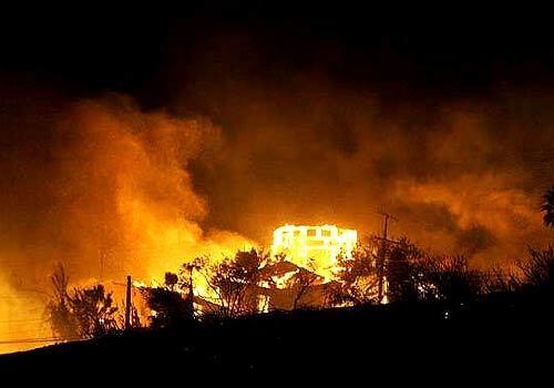 A fire fanned by Santa Ana winds destroyed four oceanfront houses and damaged several others as it burned approximately 10 acres in Malibu just south of the Pepperdine University Campus. The fire began around 5 p.m. near West Pacific Coast Highway and Malibu Canyon Road.