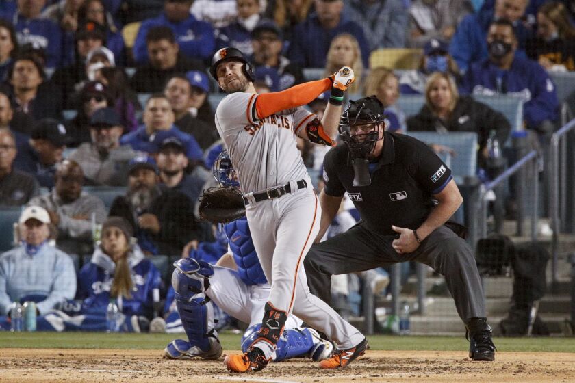 Los Angeles, CA - October 11: San Francisco Giants' Evan Longoria follows through on a swing.