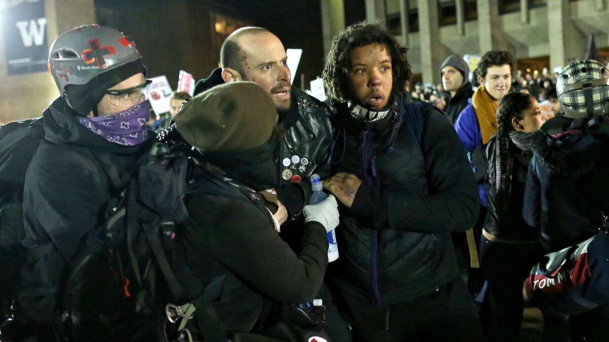 A man wounded by gunshot is assisted at a protest at the University of Washington in Seattle against an appearance by Breitbart editor Milo Yiannopoulos.