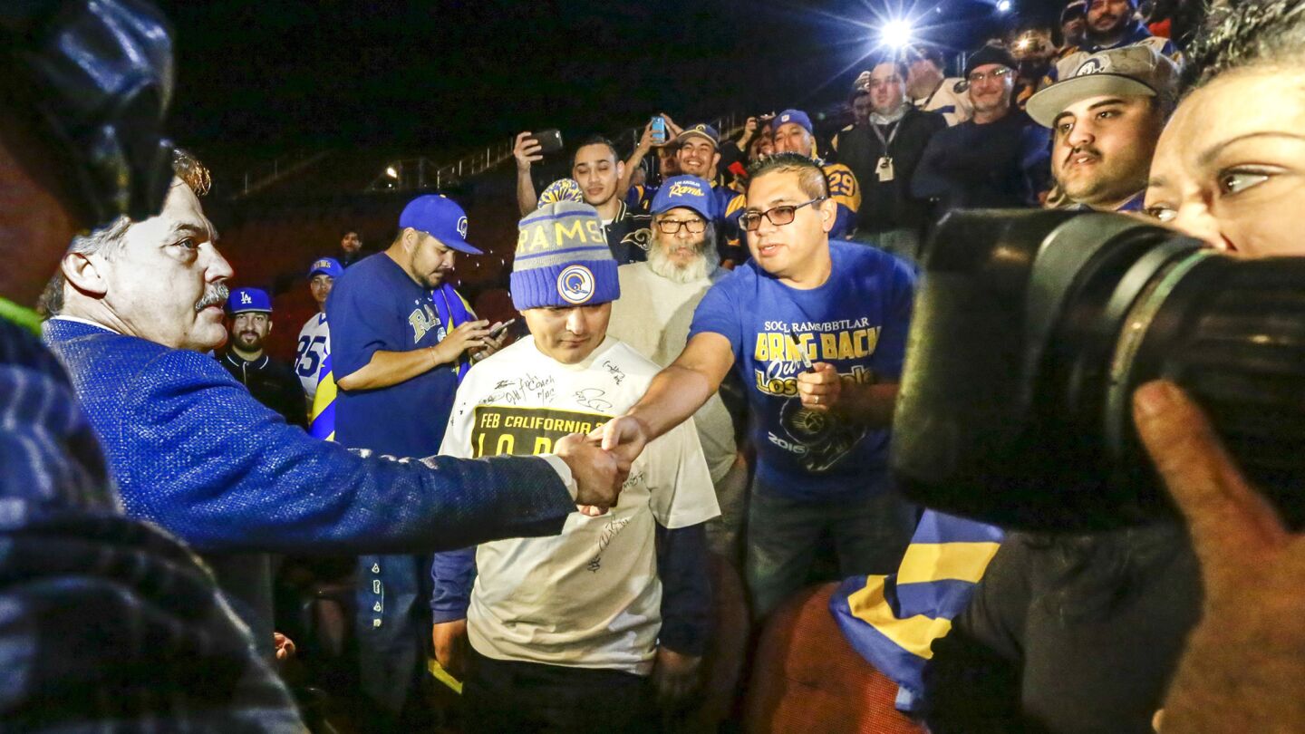 Rams Coach Jeff Fisher, left, greets fans before a news conference at the Forum in Inglewood on Jan. 15.