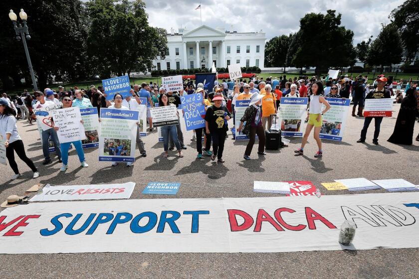 Supporters of Deferred Action for Childhood Arrivals program (DACA), layout a banner as they demonstrate on Pennsylvania Avenue in front of the White House in Washington, Sunday, Sept. 3, 2017. After months of dragging his feet, President Donald Trump will announce on Tuesday his plans for DACA program, which has given nearly 800,000 young immigrants the ability to work legally in the country and a reprieve from deportation. (AP Photo/Pablo Martinez Monsivais)