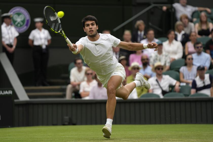 Spain's Carlos Alcaraz returns to Chile's Nicolas Jarry in a men's singles match on day six of the Wimbledon tennis championships in London, Saturday, July 8, 2023. (AP Photo/Alastair Grant)