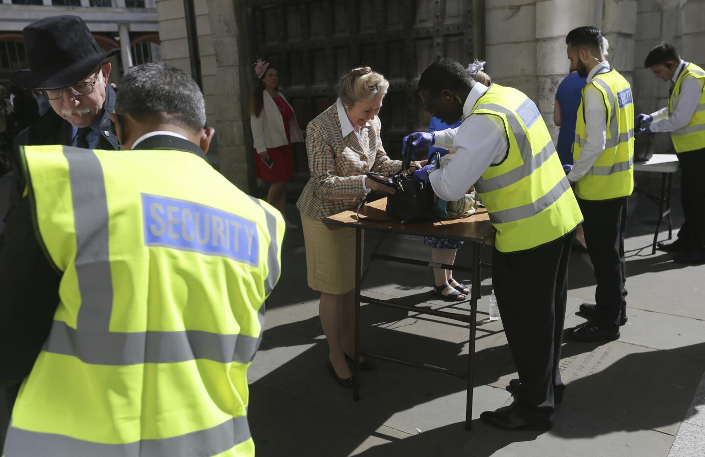 People have their bags searched outside St. Paul's Cathedral in London on May 24, 2017, ahead of a service to mark the 100th anniversary of the Order of the British Empire. Armed troops were at vital locations after the official threat level was raised to its highest point following a suicide bombing that killed 22 people.