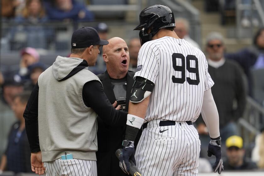 New York Yankees manager Aaron Boone, left, and Aaron Judge (99) argue with home plate umpire Ryan Blakney, center, after Blakney ejected Judge from the game in the seventh inning of a baseball game against the Detroit Tigers, Saturday, May 4, 2024, in New York. (AP Photo/Mary Altaffer)