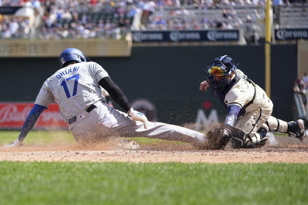 Dodgers DH Shohei Ohtani is tagged out at home plate by Twins catcher Christian Vázquez to end the top of the seventh.