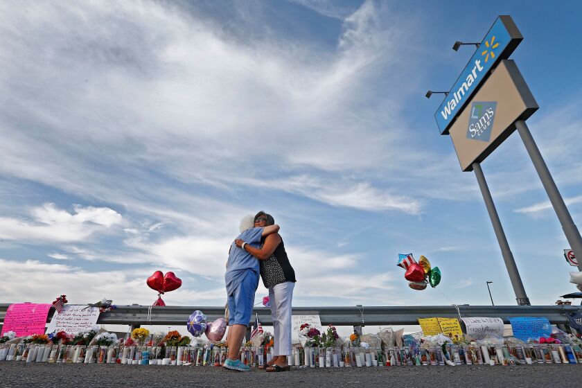 Mandatory Credit: Photo by LARRY W SMITH/EPA-EFE/REX (10354481l) Emma Del Valle (L) hugs Brenda Castaneda (R) while attending the make shift memorial along the street after the mass shooting that happened at a Walmart in El Paso, Texas, USA, 05 August 2019. Twenty people killed and forty injured from the mass shooting at the Walmart in El Paso, Texas, on 03 August 2019. Mass shooting at Wal-Mart in El Paso, Texas, USA.