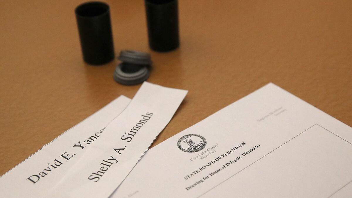 RICHMOND, VA - JANUARY 04: Slips of paper with the names of Virginia House of Delegates candidates Shelly Simonds (D-VA) and David Yancy (R-VA) are shown during a meeting of the Virginia State Board of Elections January 4, 2018 in Richmond, Virginia. The slips of paper were later placed inside old film cannisters and drawn from a bowl to decide a tied race between the two candidates. Yancey's name was pulled from the bowl and Republicans retained control of the Virginia House of Delegates, though an additional recount in the race is still possible. (Photo by Win McNamee/Getty Images) ** OUTS - ELSENT, FPG, CM - OUTS * NM, PH, VA if sourced by CT, LA or MoD **