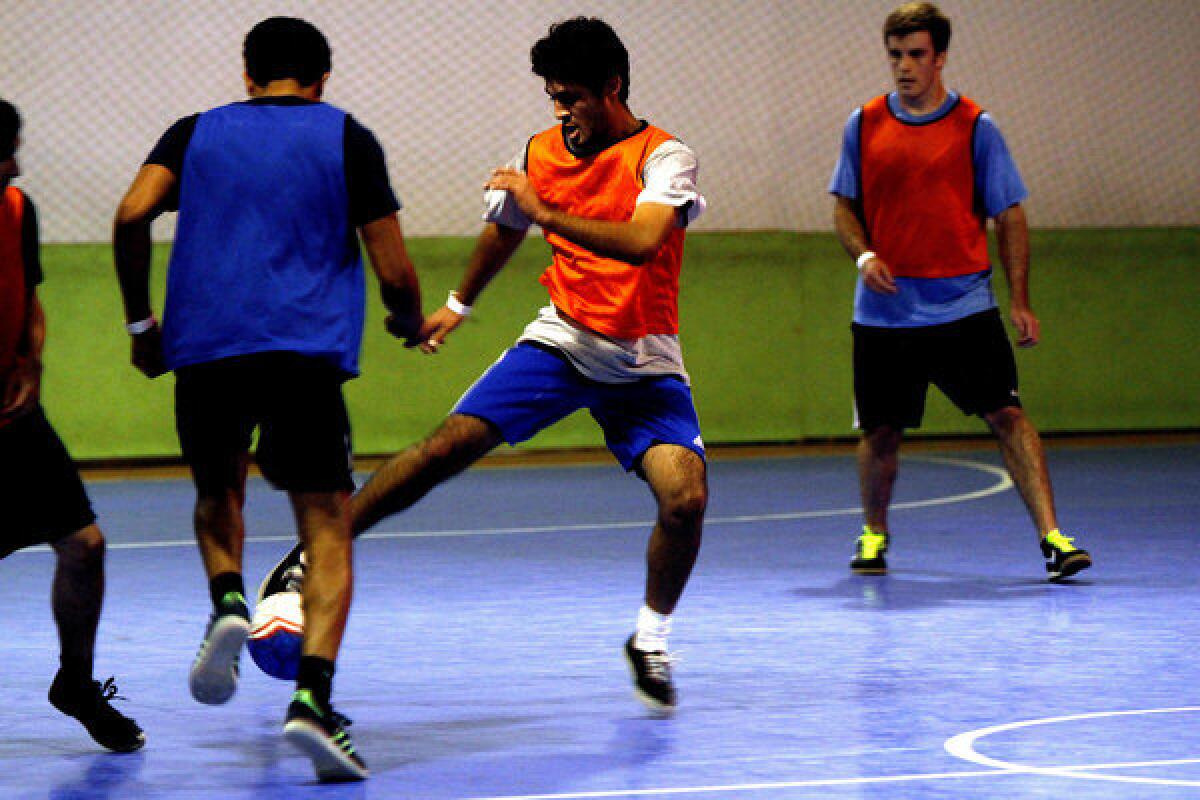 Nineteen-year-old Albert Filorio (center, orange vest) plays futsal with others at Long Beach Futsal Indoor Soccer.
