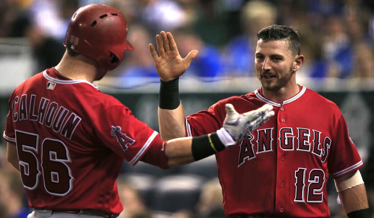 The Angels' Johnny Giavotella, right, celebrates with Kole Calhoun during the sixth inning against the Kansas City Royals on Tuesday.