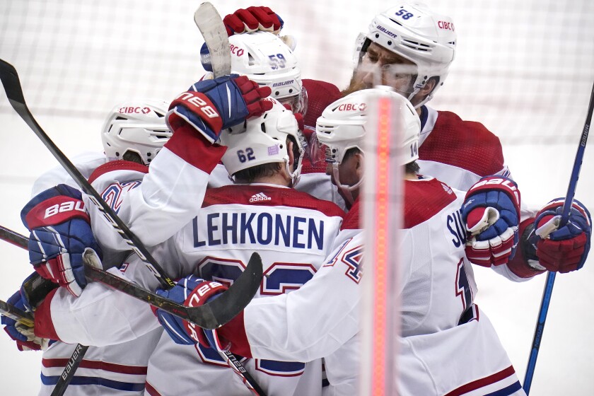 Montreal Canadiens' Artturi Lehkonen (62) celebrates with teammates after scoring during the third period of an NHL hockey game against the Pittsburgh Penguins in Pittsburgh, Saturday, Nov. 27, 2021. (AP Photo/Gene J. Puskar)