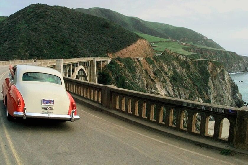 A 1959 Rolls Royce driven by Doug Effrom, of Monterey, Calif., is the first official vehicle to go across the Bixby Bridge after California Highway 1 was reopened near Big Sur, Calif., Thursday afternoon, April 30, 1998. The highway was closed after heavy storms in February damaged the road. (AP Photo/Paul Sakuma)Photo/Art by:L SAKUMA
