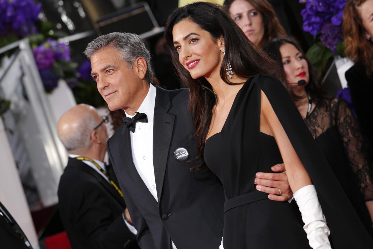 George Clooney and Amal Clooney at the 72nd Golden Globes show at the Beverly Hilton Hotel. Amal wore a pair of 29.620 carat cascading Deel diamond drop earrings set in platinum by Harry Winston.
