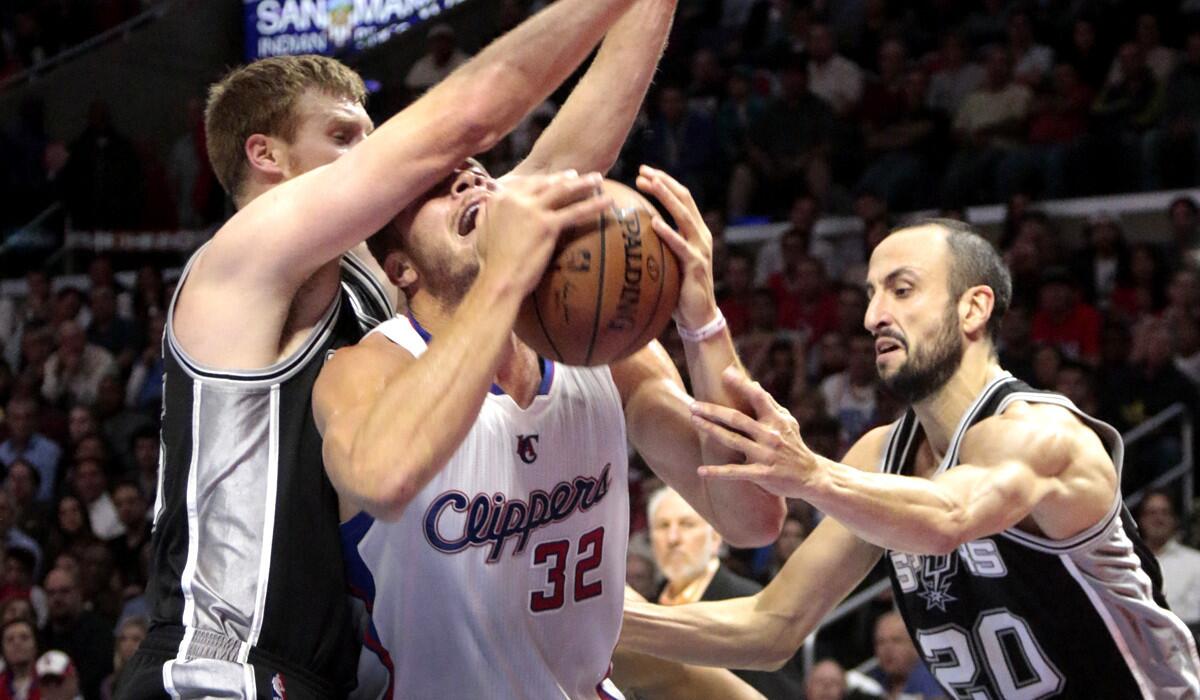 Clippers power forward Blake Griffin drives against Spurs forward Matt Bonner, left, and guard Manu Ginobili (20) in the first half.
