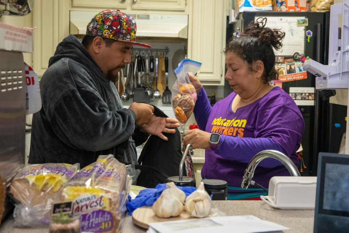 Yadira Martinez hands her 24-year-old son a bag filled with sweet bread.
