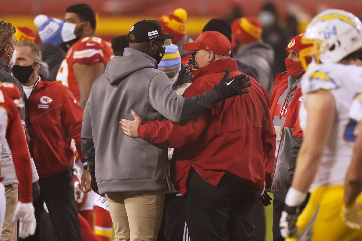 Chargers coach Anthony Lynn, left, talks with Kansas City Chiefs coach Andy Reid.
