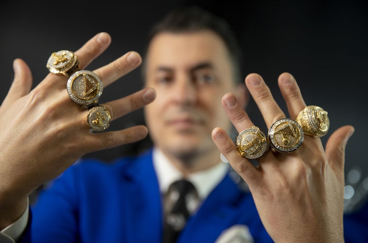 Jason Arasheben wears championship rings he designed for the Lakers and Warriors in his Beverly Hills showroom Jan. 5.